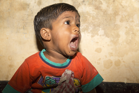 PONDICHERY, PUDUCHERRY, TAMIL NADU, INDIA 6 MARCH circa, 2018. An unidentified little beggar boy from India standing on the streetside, crying for food. Poverty conceptのeditorial素材