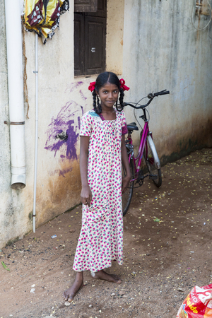 PONDICHERY, PUDUCHERRY, TAMIL NADU, INDIA - SEPTEMBER Circa, 2017. An unidentified poor girl in a small village, outdoor, looking at the cameraのeditorial素材