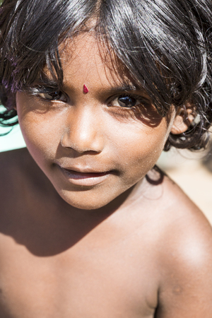 PONDICHERY, PUDUCHERRY, TAMIL NADU, INDIA - SEPTEMBER CIRCA, 2017. Portrait of unidentified Indian poor kid boy is smiling outdoor in the streetのeditorial素材
