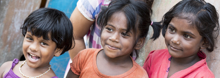 PONDICHERY, PUDUCHERRY, TAMIL NADU, INDIA - SEPTEMBER CIRCA, 2017. Portrait of 3 unidentified Indian poor kid child girl is smiling outdoor in the street.のeditorial素材