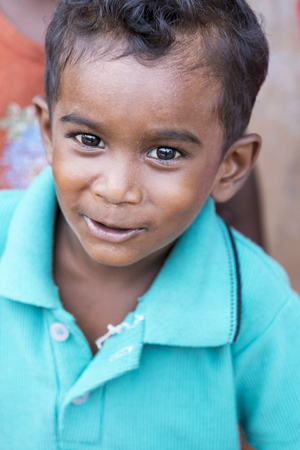 PONDICHERY, PUDUCHERRY, TAMIL NADU, INDIA - SEPTEMBER CIRCA, 2017. Portrait of unidentified Indian poor kid boy is smiling outdoor in the streetのeditorial素材