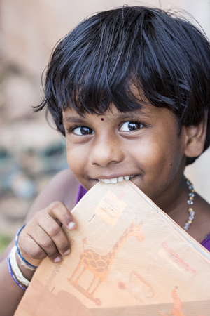 PONDICHERY, PUDUCHERRY, TAMIL NADU, INDIA - SEPTEMBER CIRCA, 2017. Portrait of unidentified Indian poor kid child girl is smiling outdoor in the streetのeditorial素材