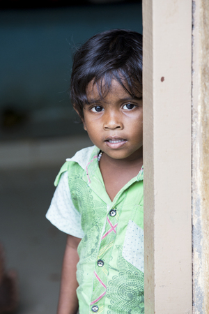 PONDICHERY, PUDUCHERRY, TAMIL NADU, INDIA - SEPTEMBER CIRCA, 2017. Portrait of unidentified Indian poor kid boy is smiling outdoor in the streetのeditorial素材