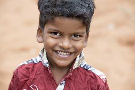 PONDICHERY, PUDUCHERRY, TAMIL NADU, INDIA - SEPTEMBER CIRCA, 2017. Portrait of unidentified Indian poor kid boy is smiling outdoor in the streetのeditorial素材