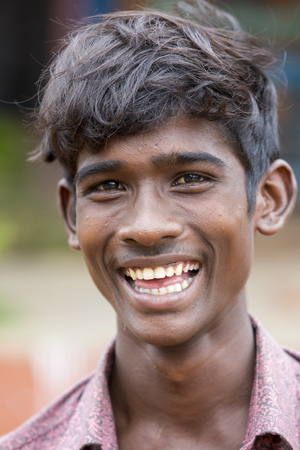 PONDICHERY, PUDUCHERRY, TAMIL NADU, INDIA - SEPTEMBER CIRCA, 2017. Portrait of unidentified Indian poor kid boy is smiling outdoor in the streetのeditorial素材