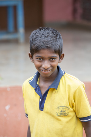 PONDICHERY, PUDUCHERRY, TAMIL NADU, INDIA - SEPTEMBER CIRCA, 2017. Portrait of unidentified Indian poor kid boy is smiling outdoor in the streetのeditorial素材