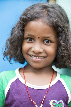 PONDICHERY, PUDUCHERRY, TAMIL NADU, INDIA - SEPTEMBER CIRCA, 2017. Portrait of unidentified Indian poor kid child girl is smiling outdoor in the streetのeditorial素材