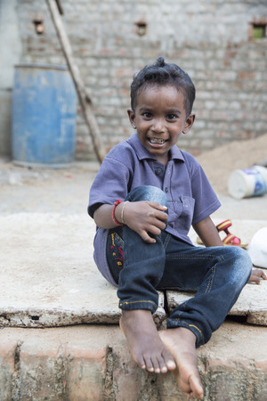 PONDICHERY, PUDUCHERRY, TAMIL NADU, INDIA - SEPTEMBER CIRCA, 2017. Portrait of unidentified Indian poor kid boy is smiling outdoor in the streetのeditorial素材