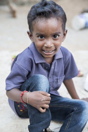 PONDICHERY, PUDUCHERRY, TAMIL NADU, INDIA - SEPTEMBER CIRCA, 2017. Portrait of unidentified Indian poor kid boy is smiling outdoor in the streetのeditorial素材