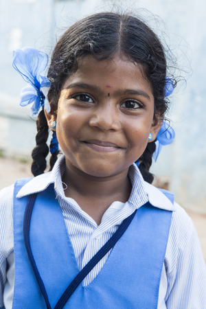 PONDICHERY, PUDUCHERRY, TAMIL NADU, INDIA - SEPTEMBER CIRCA, 2017. Portrait of unidentified Indian poor kid child girl is smiling outdoor in the streetのeditorial素材