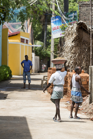 PONDICHERY, PUDUCHERRY, TAMIL NADU, INDIA - SEPTEMBER CIRCA, 2018. Unidentified Workers work at the construction site. Work is under way to lay a wall of red brick.のeditorial素材