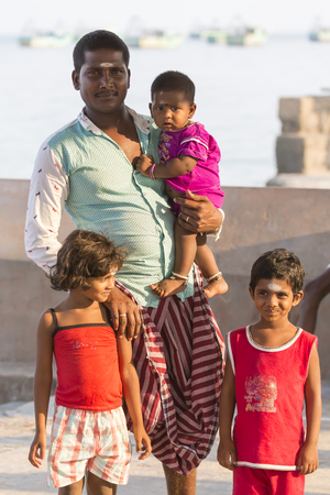 RAMESHWARAM, TAMIL NADU, INDIA - MARCH CIRCA, 2018. Smiling indian child in the arms of his father.のeditorial素材