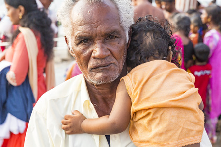 RAMESHWARAM, TAMIL NADU, INDIA - MARCH CIRCA, 2018. Smiling indian child in the arms of his father.のeditorial素材
