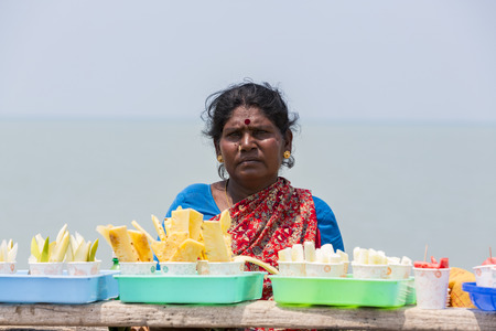 RAMESHWARAM, TAMIL NADU, INDIA - MARCH CIRCA, 2018. Unidentified Indian trader woman in her shop on local market selling all kind of goods, fuits, vegetablesのeditorial素材