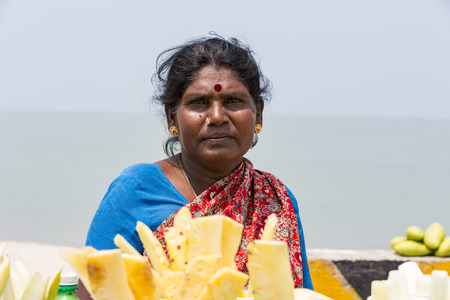 RAMESHWARAM, TAMIL NADU, INDIA - MARCH CIRCA, 2018. Unidentified Indian trader woman in her shop on local market selling all kind of goods, fuits, vegetablesのeditorial素材