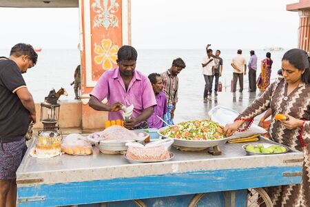 RAMESHWARAM, TAMIL NADU, INDIA - MARCH CIRCA, 2018. Unidentified Indian trader in his shop on local market selling all kind of goods, fuits, vegetables, peanuts.のeditorial素材