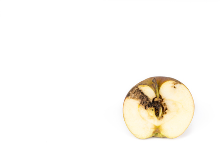 Close-up Boring trace of a codling moth Cydia Pomonella, in a half wormy apple. On white background. Place to writeの写真素材