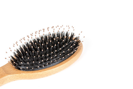 Wood hairbrush on white background. Close-up without hair. Hair Loss problemの写真素材