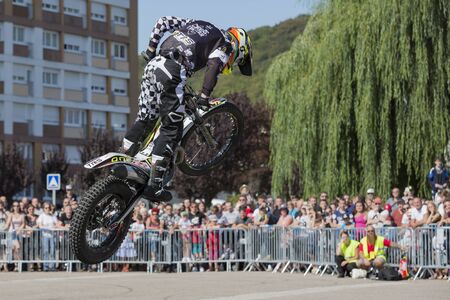LE TRAIT, SEINE MARITIME, NORMANDY, FRANCE - SEPTEMBER 01, 2018. Moto-show in central square of city. Tricks on ATV stuntmen, Stunt Riding - Wheelie, Stoppie, jump in the air and extreme acrobatics somersault on motorbike with platform. Outdoor spectacleのeditorial素材