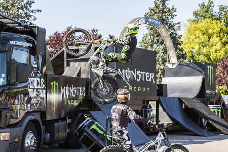 LE TRAIT, SEINE MARITIME, NORMANDY, FRANCE - SEPTEMBER 01, 2018. Moto-show in central square of city. Tricks on ATV stuntmen, Stunt Riding - Wheelie, Stoppie, jump in the air and extreme acrobatics somersault on motorbike with platform. Outdoor spectacleのeditorial素材