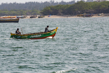 Old wood small fishing boat floating on the water, India
