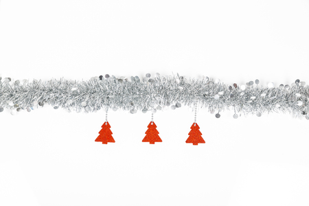 Christmas silver grey garland photo with red trees paper on white background.の写真素材