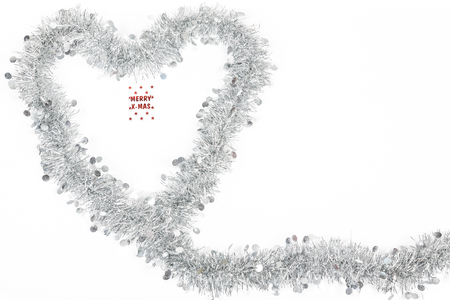 Christmas silver grey garland decoration photo as a heart for love emtion with a Merry Christmas label on white background.の写真素材
