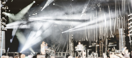 Soft motion blur blurred creativity filter rock band vocalist singer performing on stage music. Guitarist bass guitar drum saxophone. Scene light. Authentic shooting whith high iso in challenging lighting conditionsの写真素材