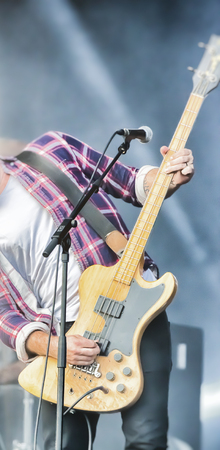 Soft motion blur blurred creativity filter rock band vocalist singer performing on stage music. Guitarist bass guitar drum saxophone. Scene light. Authentic shooting whith high iso in challenging lighting conditionsの写真素材