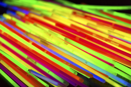 Variation of multicolored colorful colored fluorescent chem light neon tube with reflection on...