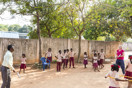 PUDUCHERY, INDIA - MARCH Circa, 2018 : Unidentified french european playing game badminton with director school with boys and girls smiling, happy, excited, funny. Multiracial and charity ngo concept. Panoramic bannerのeditorial素材