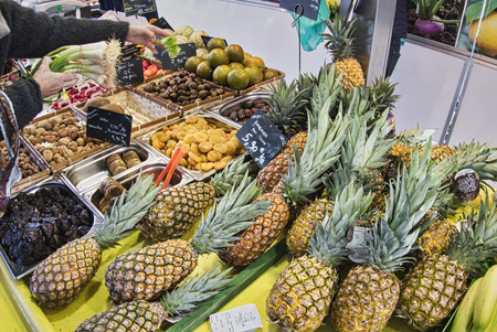 St Vaast, France - December circa, 2018. Exotic fruits. Market stall with variety of organic fruits. Colorful fruits in the marketplace. Bright summer background. Healthy, organic food. Natural nutrition for diet.のeditorial素材