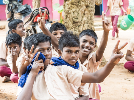 PUDUCHERRY, INDIA - DECEMBER Circa, 2018. Unidentified group best children boys friends classmates in government school uniforms smiling laughing at school, showing thum up gesture. Portrait of multi ethnic school kids enjoying friendship.のeditorial素材
