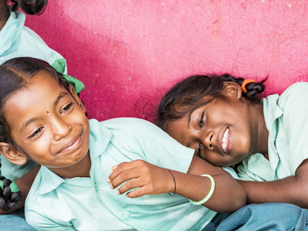 PUDUCHERRY, INDIA - DECEMBER Circa, 2018. Unidentified group best children girls friends classmates in government school uniforms smiling laughing at school. Portrait of school kids enjoying friendship.のeditorial素材