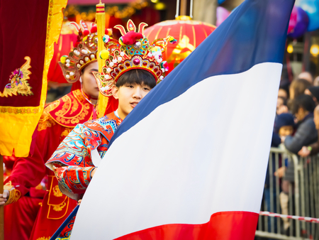 PARIS, FRANCE - FEBRUARY 17, 2019. Last day of the chinese new year celebration festival in street. People show walking with colorful costumes and decorations. 200 thousands, multi ethnic asian man woman. Year of pigのeditorial素材