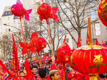 PARIS, FRANCE - FEBRUARY 17, 2019. Last day of the chinese new year celebration festival in street. People show walking with colorful costumes and decorations. 200 thousands, multi ethnic asian man woman. Year of pigのeditorial素材