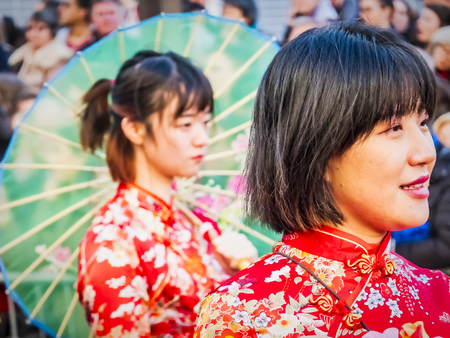 PARIS, FRANCE - FEBRUARY 17, 2019. Last day of the chinese new year celebration festival in street. Portrait of woman show with colorful costumes and decorations. Happy face and concentration. Year of pigのeditorial素材