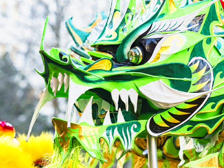 PARIS, FRANCE - FEBRUARY 17, 2019. Last day of the chinese new year celebration festival in street. Dance of colorful green dragons in the street during the parade festival. Close up head of dragon. Traditional celebration.のeditorial素材