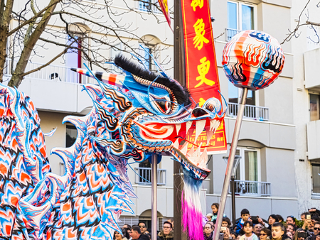 PARIS, FRANCE - FEBRUARY 17, 2019. Last day of the chinese new year celebration festival in street. Dance of colorful blue dragons in the street during the parade festival. Close up head of dragon. Traditional celebration.のeditorial素材