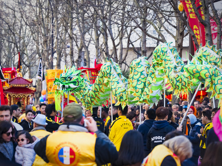 PARIS, FRANCE - FEBRUARY 17, 2019. Last day of the chinese new year celebration festival in street. Dance of colorful green dragons in the street during the parade festival. Traditional celebration.のeditorial素材