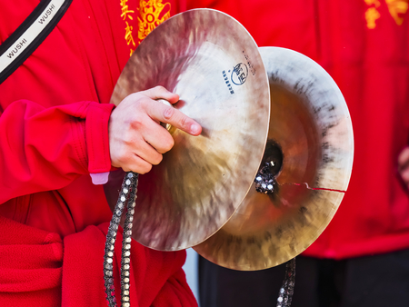 PARIS, FRANCE - FEBRUARY 17, 2019. Last day of the chinese new year celebration festival. Musician playing cymbal in the street during the parade festival. Traditional celebration and costumes.のeditorial素材