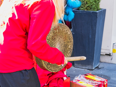 PARIS, FRANCE - FEBRUARY 17, 2019. Last day of the chinese new year celebration festival. Musician playing gong in the street during the parade festival. Traditional celebration and costumes.のeditorial素材