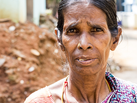PUDUCHERY, INDIA - DECEMBER Circa, 2018. Unidentified portrait of an Asian indian poor woman in native dress sari looking at the camera. Very skinny and sad face expressionのeditorial素材