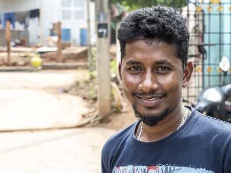 PUDUCHERY, INDIA - DECEMBER Circa, 2018. Unidentified young casual adult outdoors looking at the...