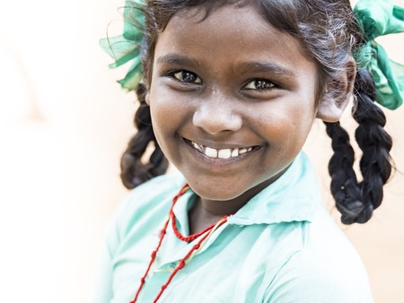 PUDUCHERY, INDIA - DECEMBER Circa, 2018. Portrait of unidentified handsome cute smiling indian girl outdoors. Concept of joyful even if they are poor people.のeditorial素材