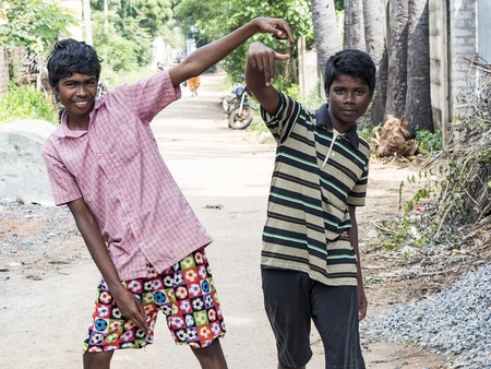 PUDUCHERY, INDIA - DECEMBER Circa, 2018. Two unidentified teenagers asian indian two boys looking at...