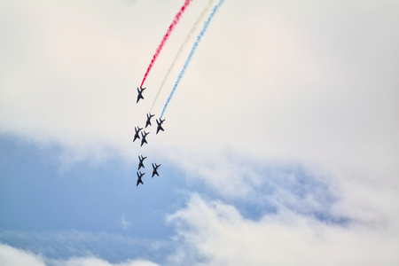 LE BOURGET, FRANCE - June 24, 2017. Flying display and aerobatics show in the sky with red blue white smoke. French Patrouille de France team performing at International Airshow aerobatics aeronautical and spatial meeting.のeditorial素材