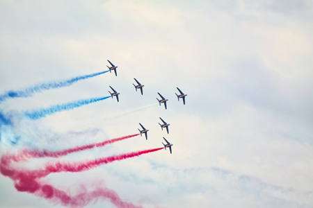 LE BOURGET, FRANCE - June 24, 2017. Flying display and aerobatics show in the sky with red blue...