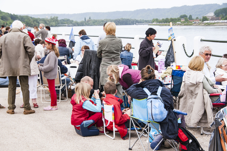 YAINVILLE, FRANCE - JULY Circa 2016. Big village picnic for the Aramada parade exhibition, along the river Seine. Pepole waiting for the boats ships, eating.のeditorial素材