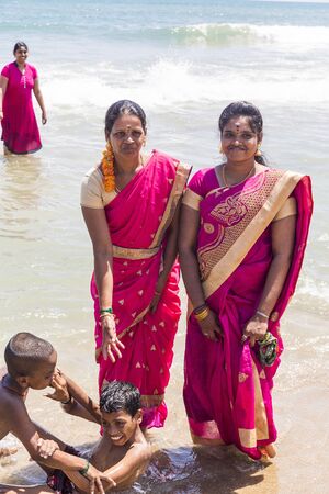 MASI MAGAM FESTIVAL, PUDUCHERY, PONDICHERY, TAMIL NADU, INDIA - March 1, 2018. Group of unidentified Indian pilgrims women men bathing in the sea, on the beachのeditorial素材